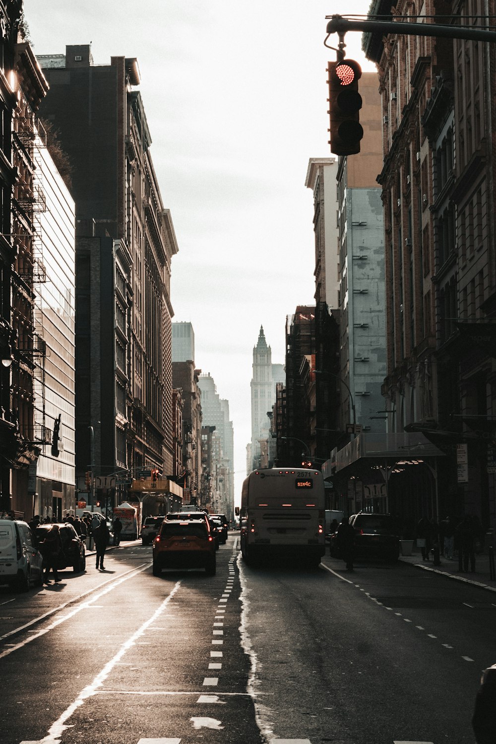 a city street filled with traffic next to tall buildings