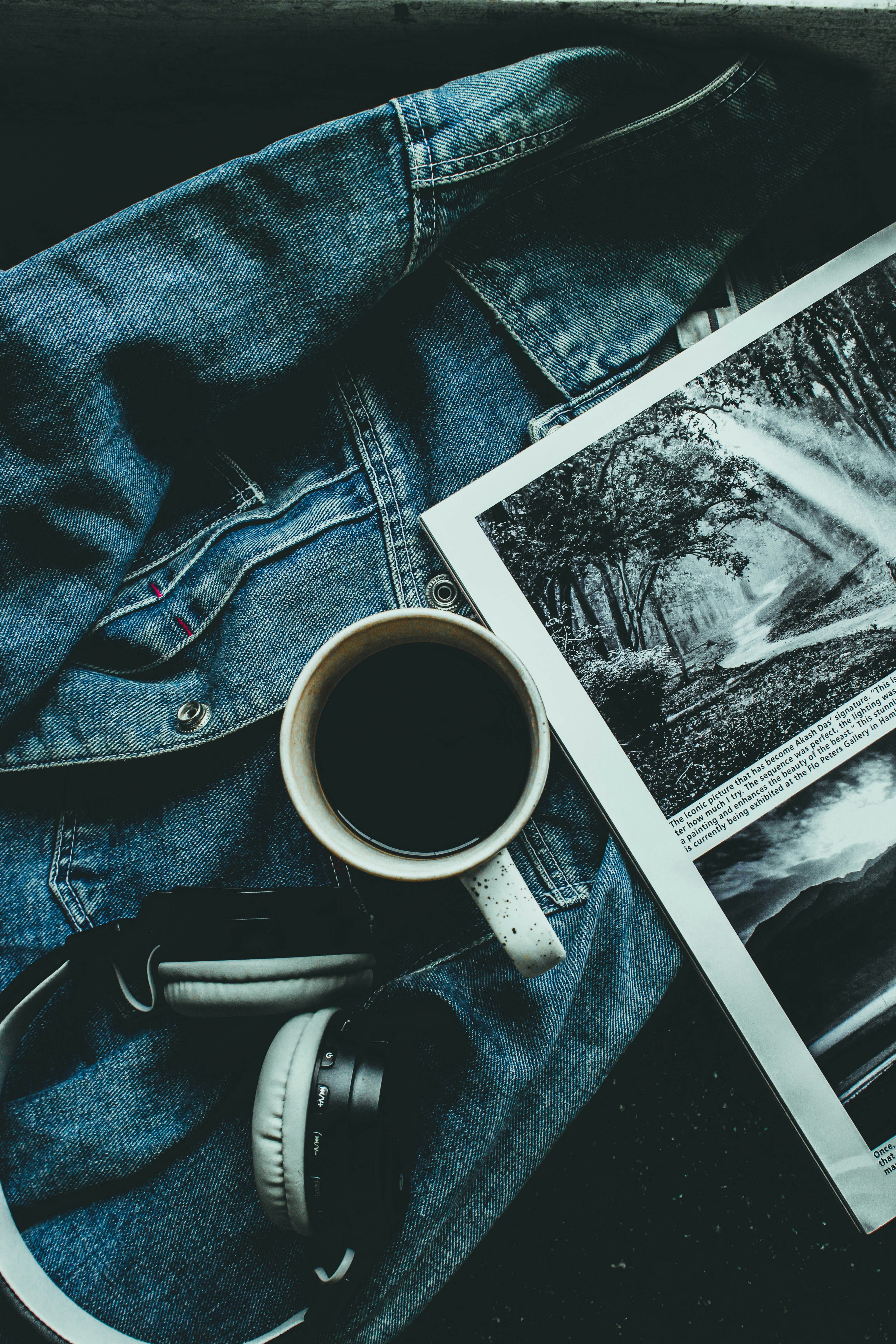 a pair of headphones sitting on top of a pair of jeans