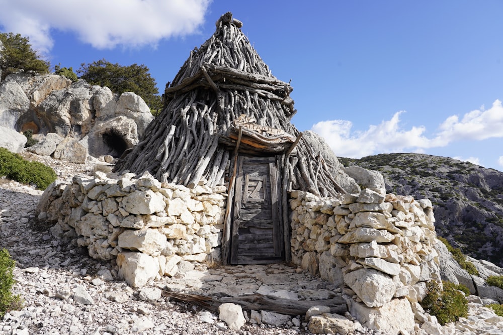 a small hut made of rocks and wood