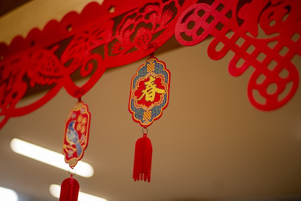 a red and blue decoration hanging from a ceiling