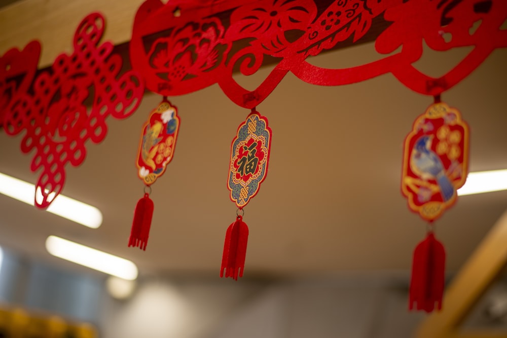 a group of red decorations hanging from a ceiling