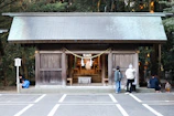 Travelers gathered around a traditional Korean shrine, immersed in storytelling.