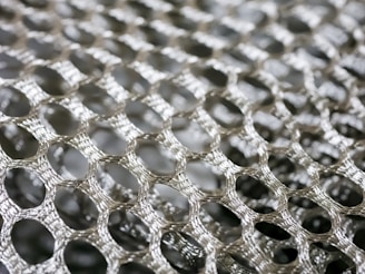 A close-up of stainless steel wire mesh showcasing its intricate pattern.