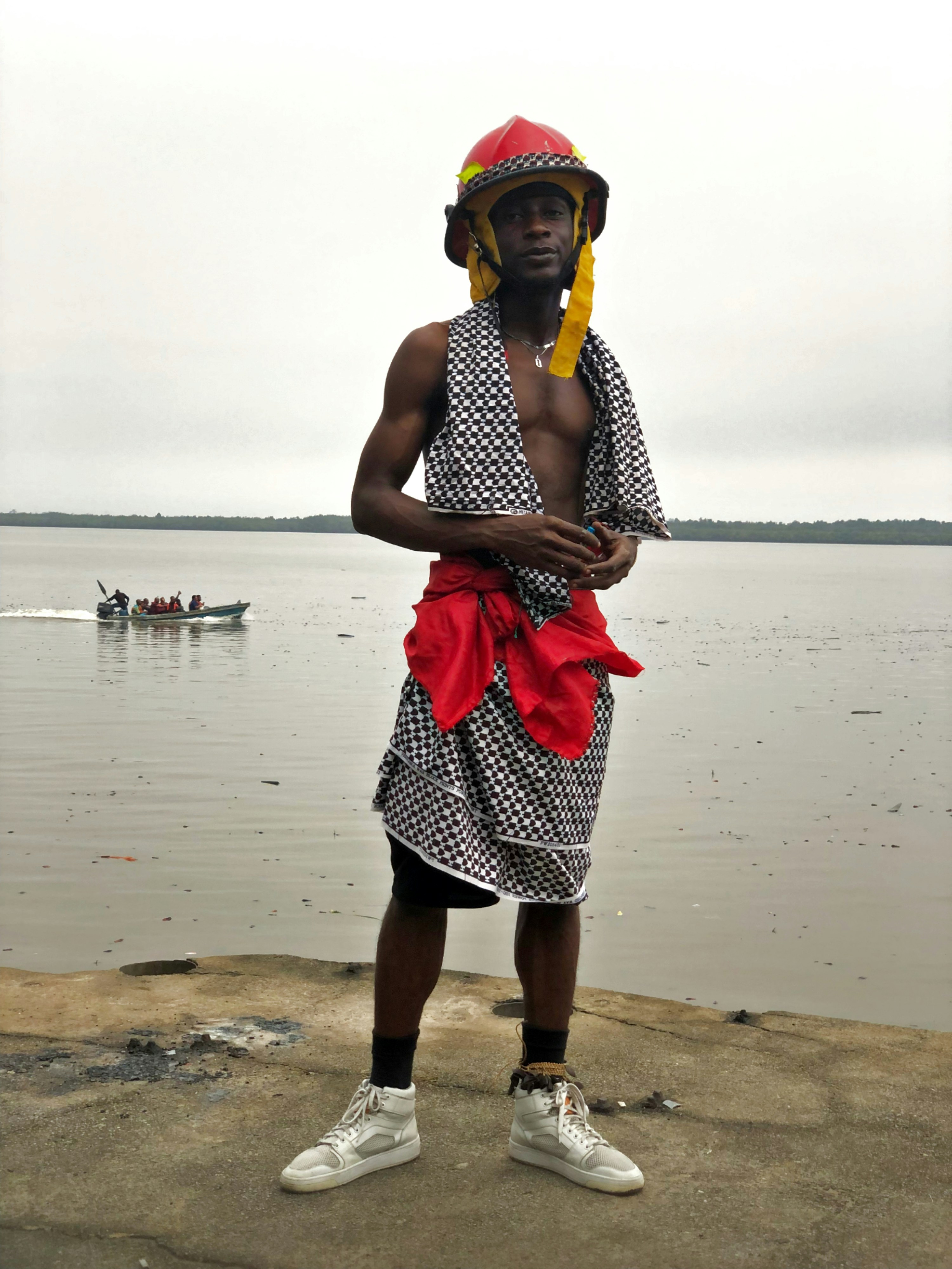 a man standing on a rock next to a body of water