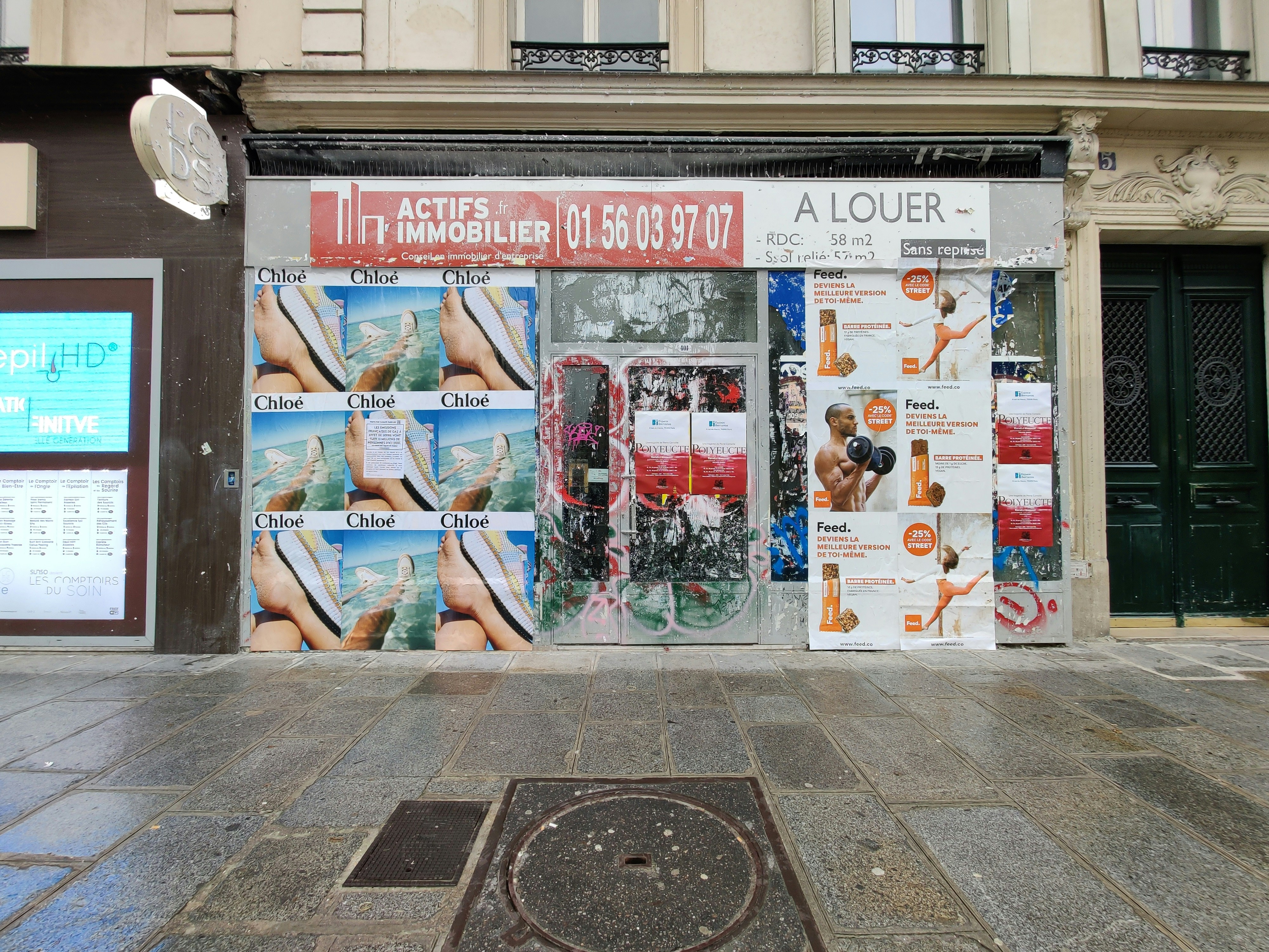 a store front with a lot of advertisements on it