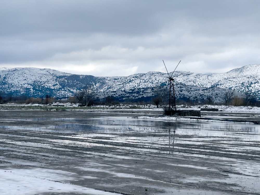 a windmill in the middle of a frozen lake