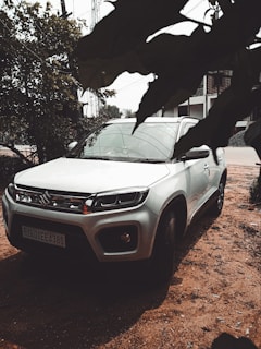 a white car parked on a dirt road