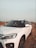 a white car parked on a dirt road
