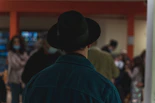 a man wearing a black hat in a crowd of people
