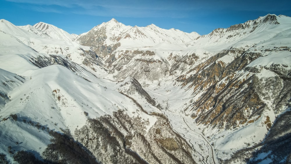 a view of a snowy mountain range from an airplane