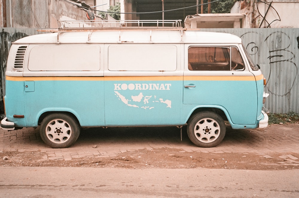 a blue and white van parked in front of a building