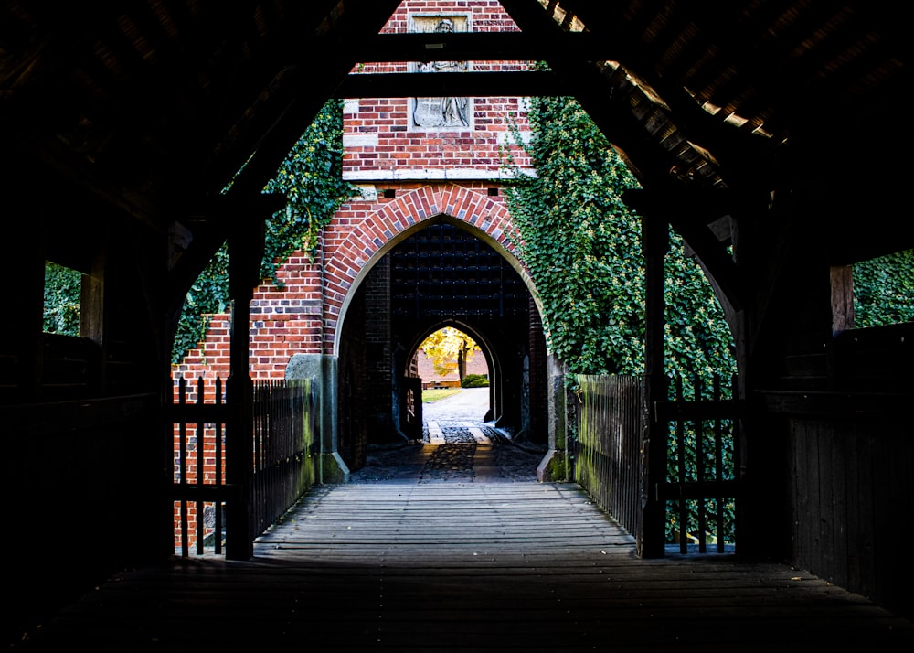 a wooden walkway leading to a brick building