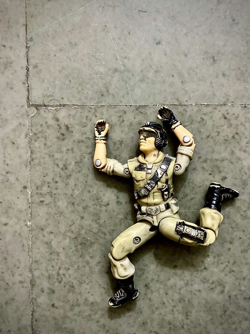 a toy figurine is laying on the ground