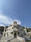 a large white building with stairs leading up to it