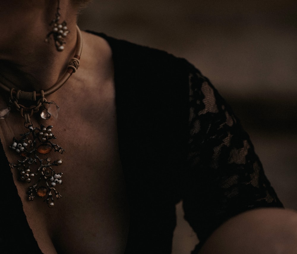 a close up of a woman wearing a necklace