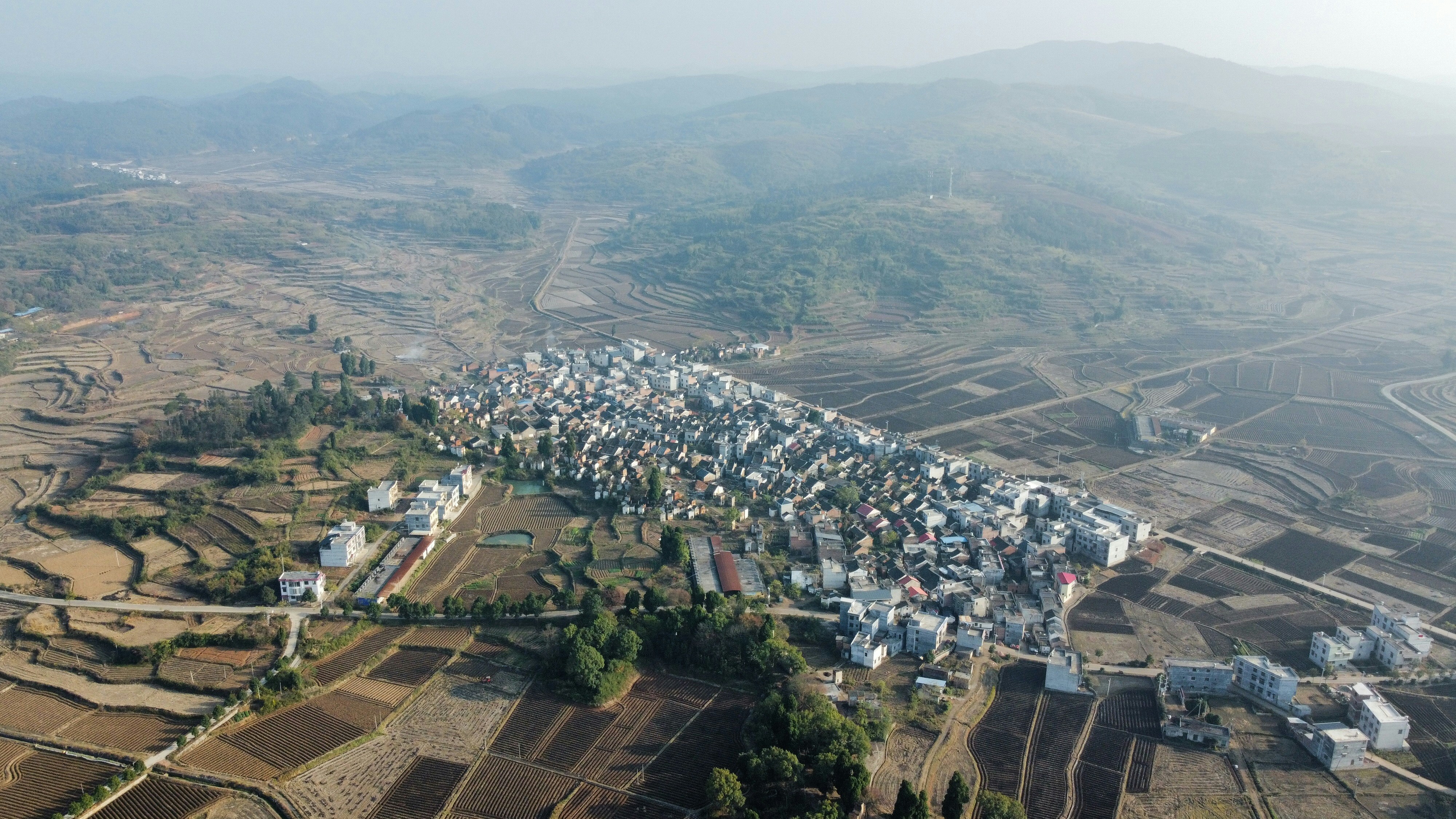 an aerial view of a village in the mountains