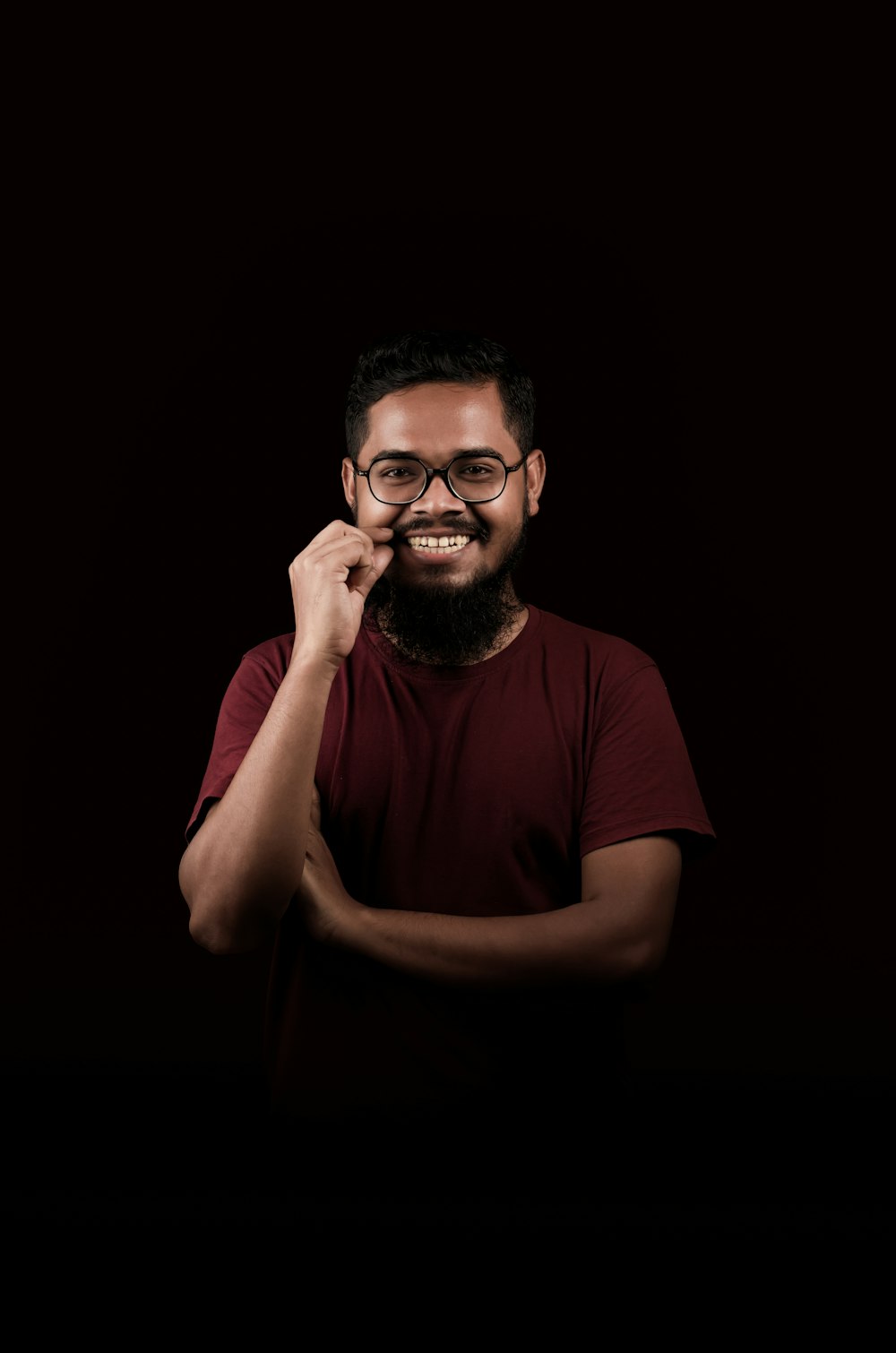 a man with a beard and glasses posing for a picture