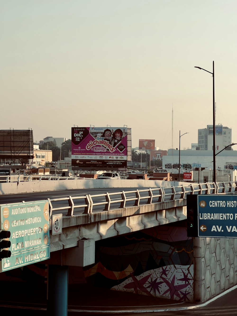 a bridge over a street with a bunch of signs on it