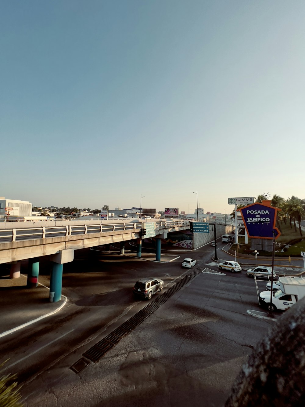 a freeway filled with lots of traffic under a blue sky