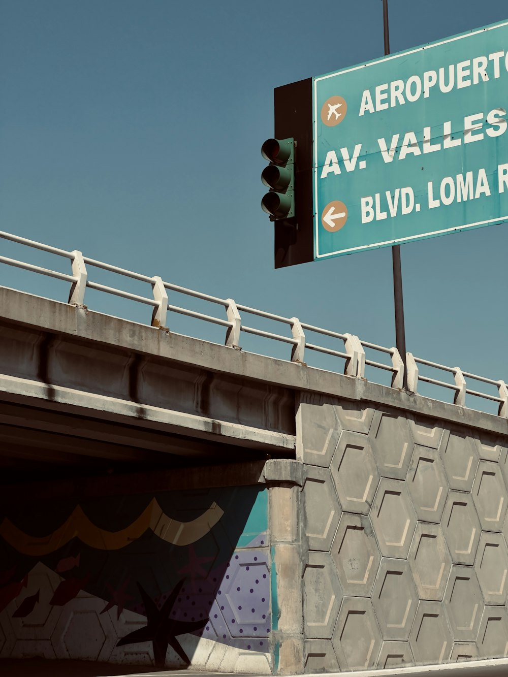 a street sign on the side of a bridge