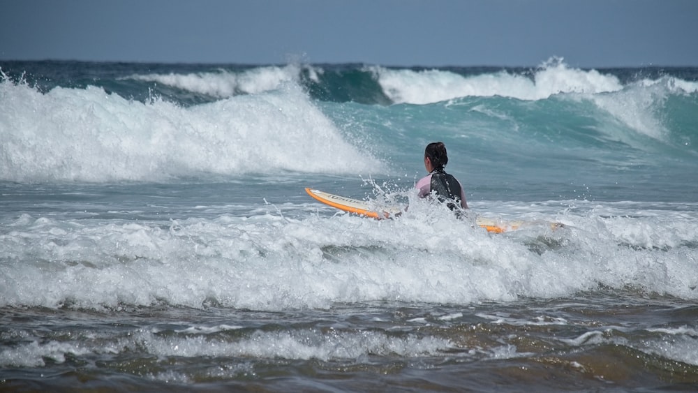 a person riding a surfboard on a wave in the ocean