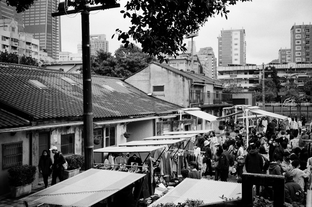 a black and white photo of a crowded street