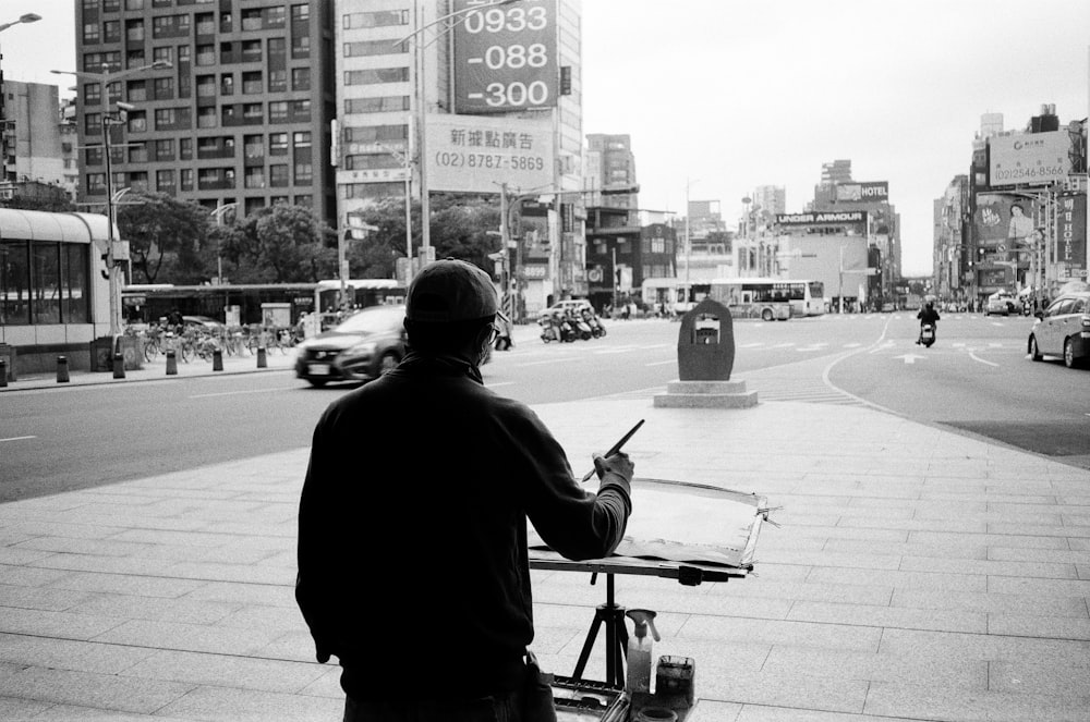 a man sitting on a bench in the middle of a city