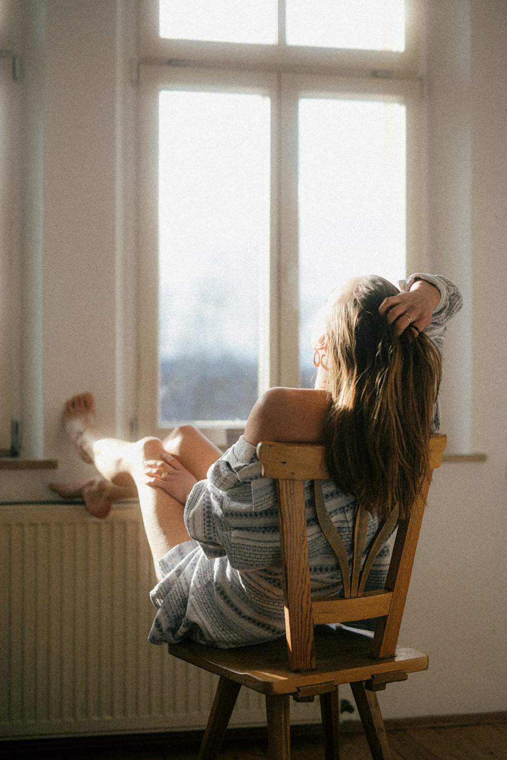 a woman sitting in a chair reading a book