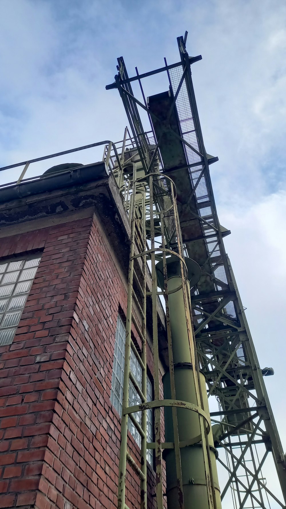 a tall brick building with a metal staircase going up it's side