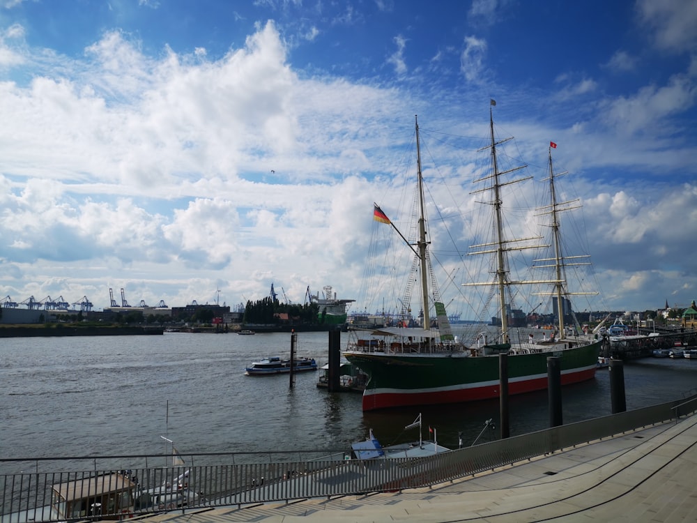 a large boat is docked at a pier