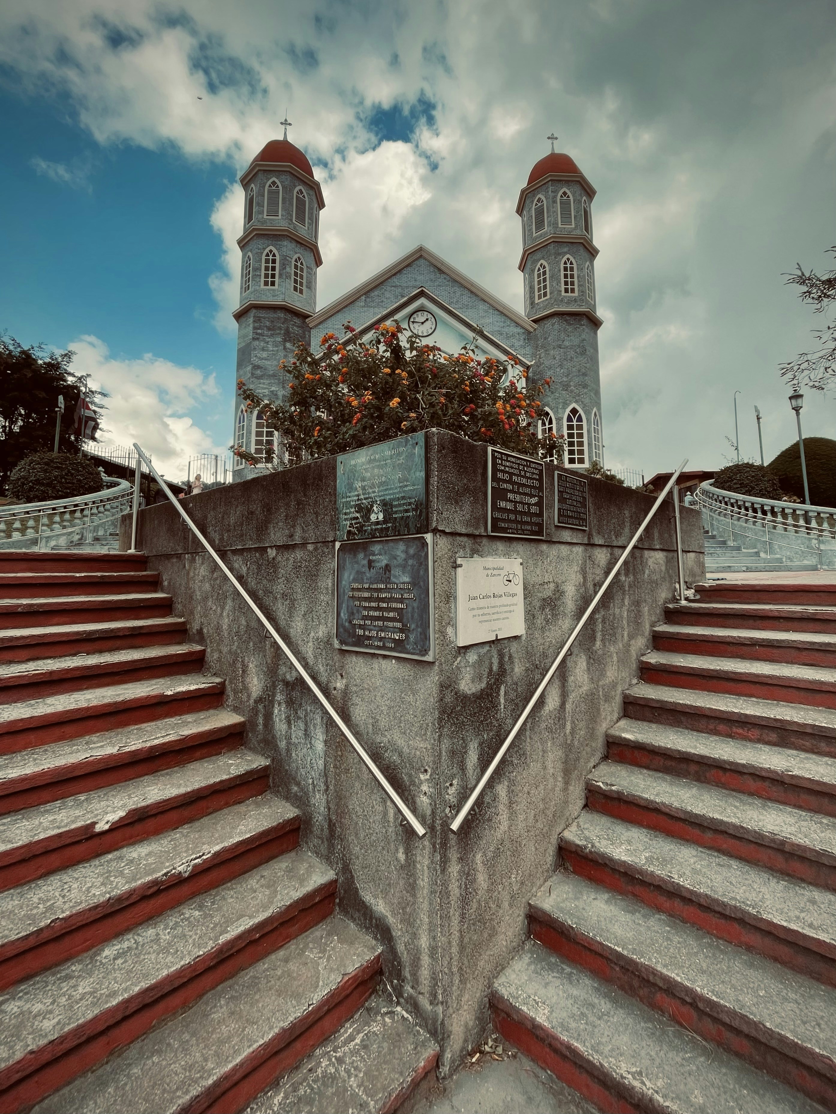 sebuah bangunan dengan menara dan bunga di atasnya