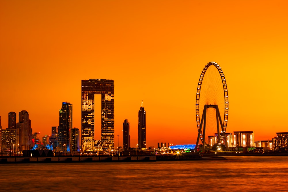 a city skyline with a ferris wheel in the foreground