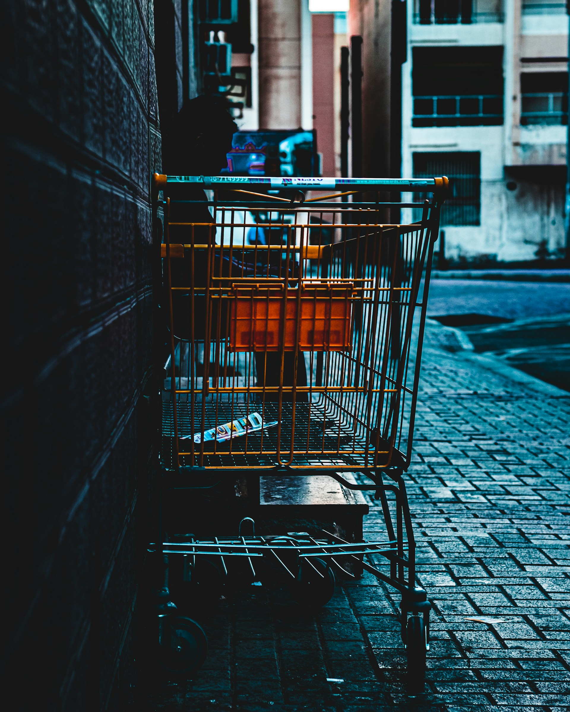 a shopping cart sitting on the side of a street
