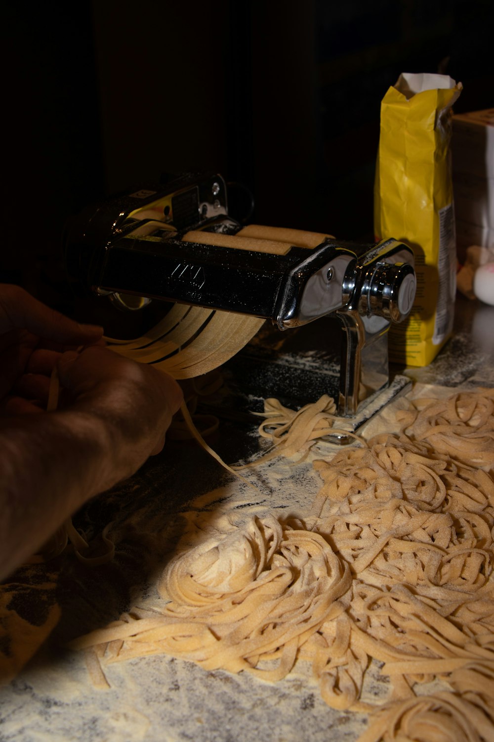 a person is working on a pasta machine
