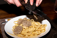 a plate of pasta with meatballs and a knife