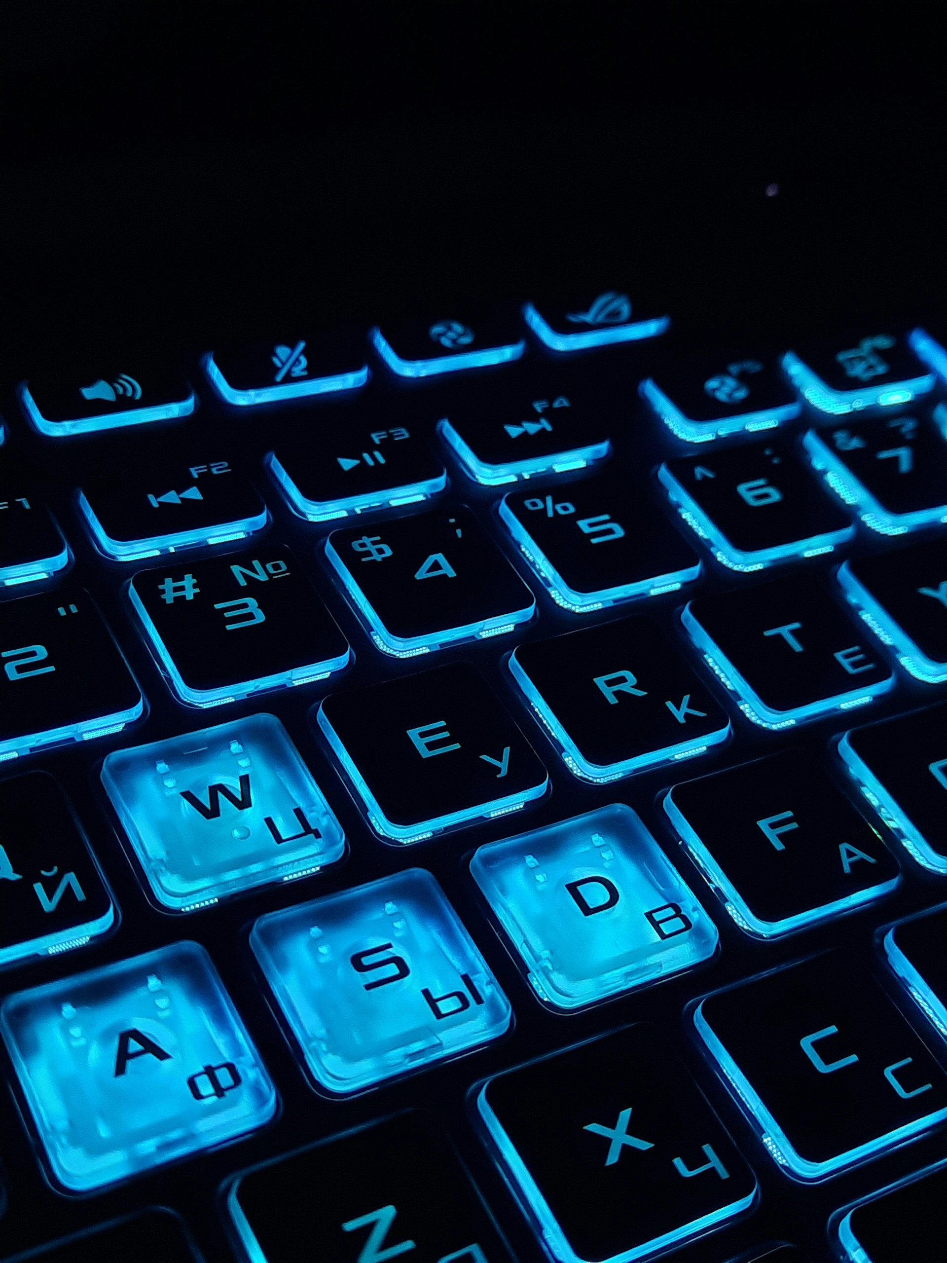 a close up of a keyboard with blue keys