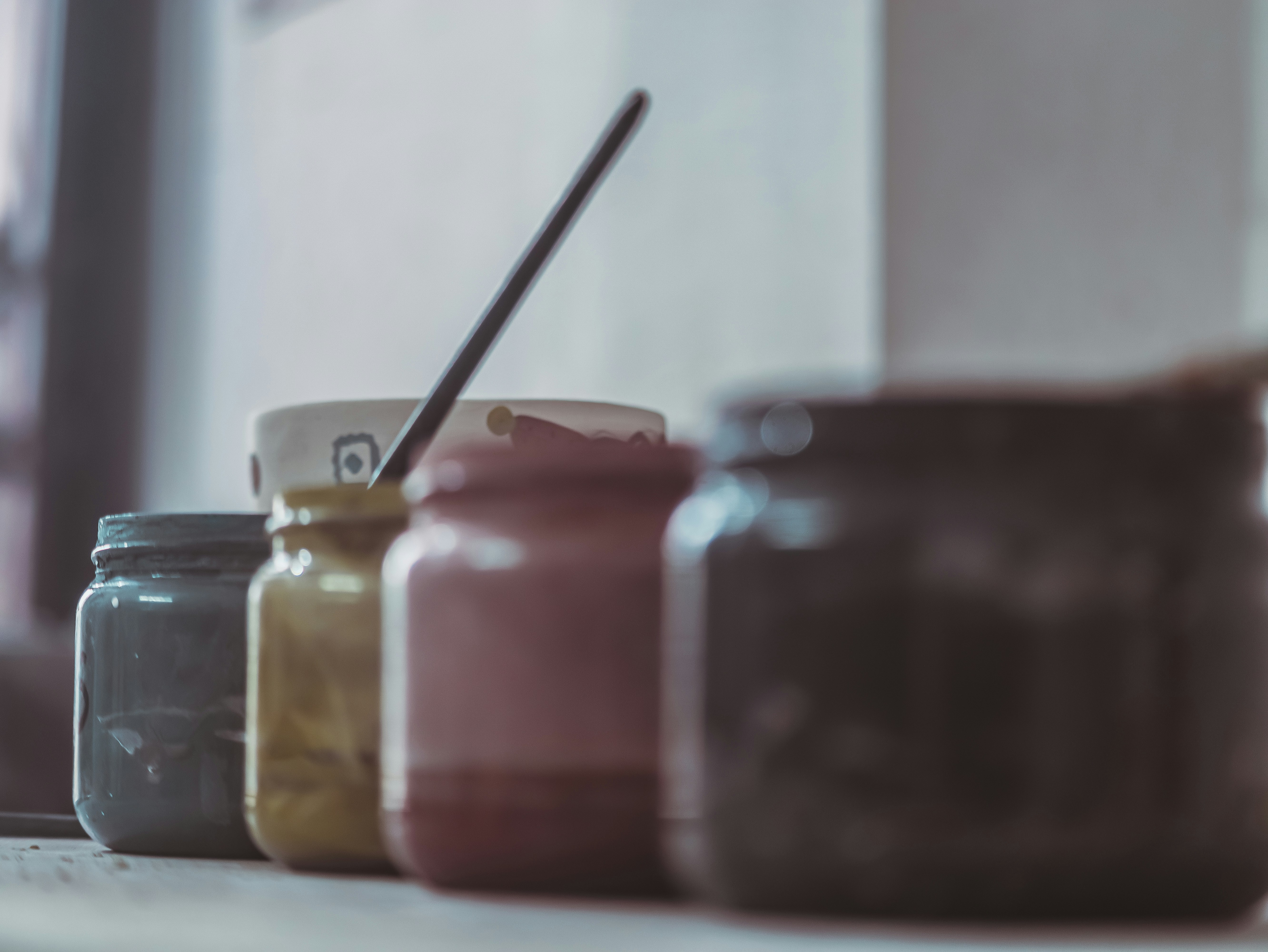 a row of jars sitting on top of a counter
