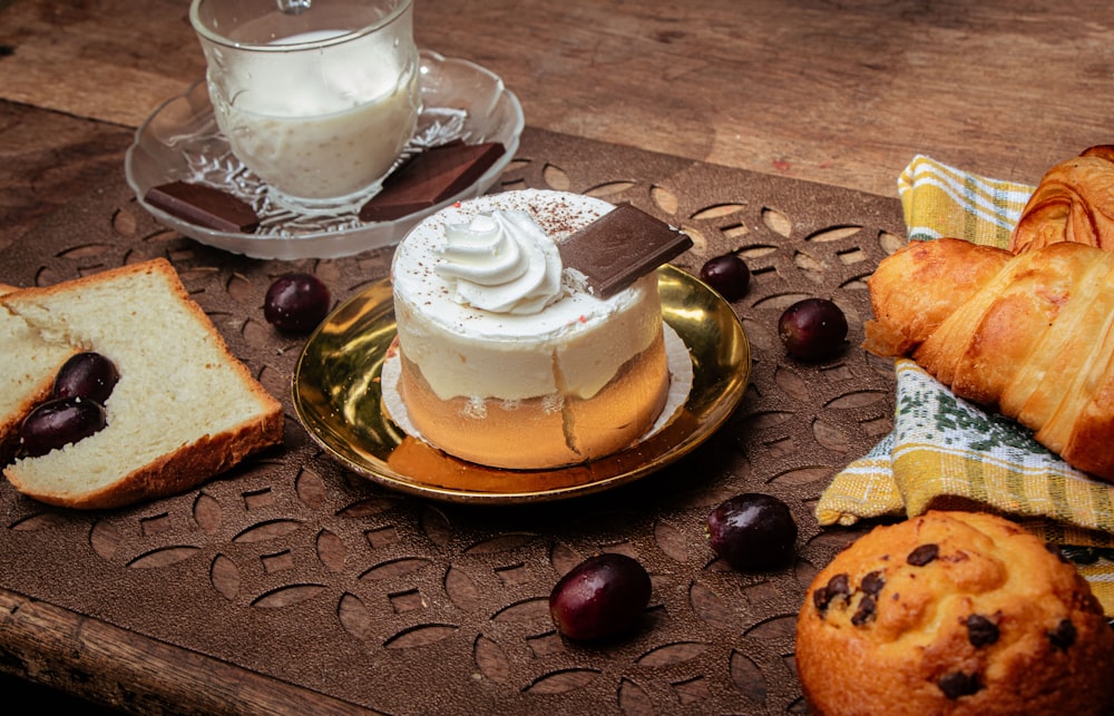 a wooden table topped with pastries and bread