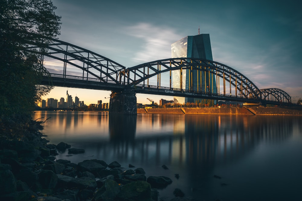 a train crossing a bridge over a body of water