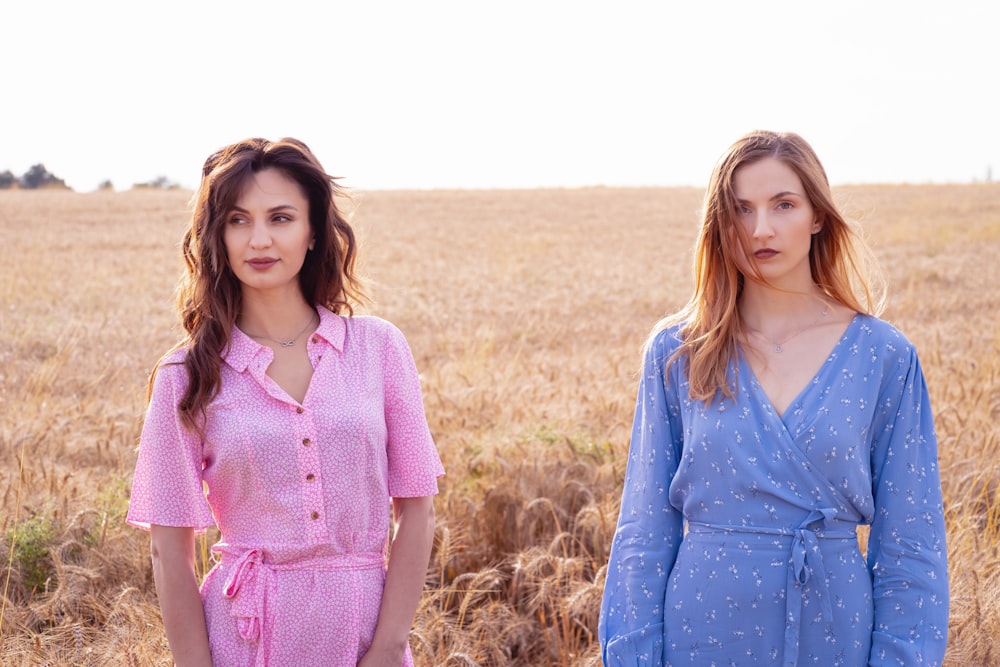 two women standing in a field of wheat