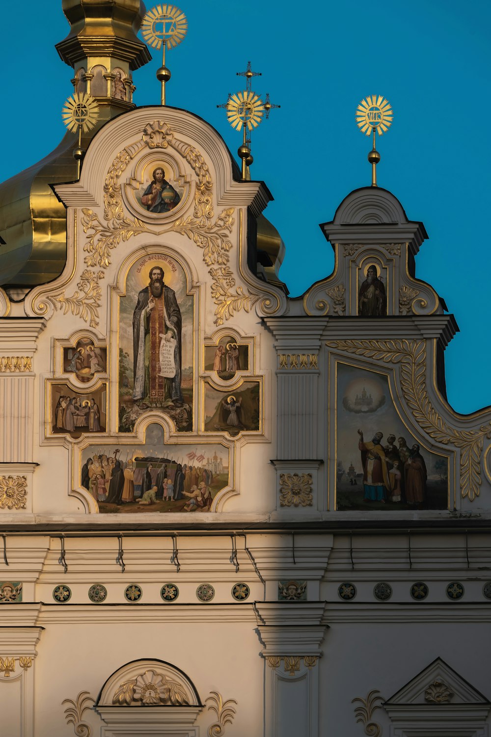 a church with a golden dome and a painting on the side of it