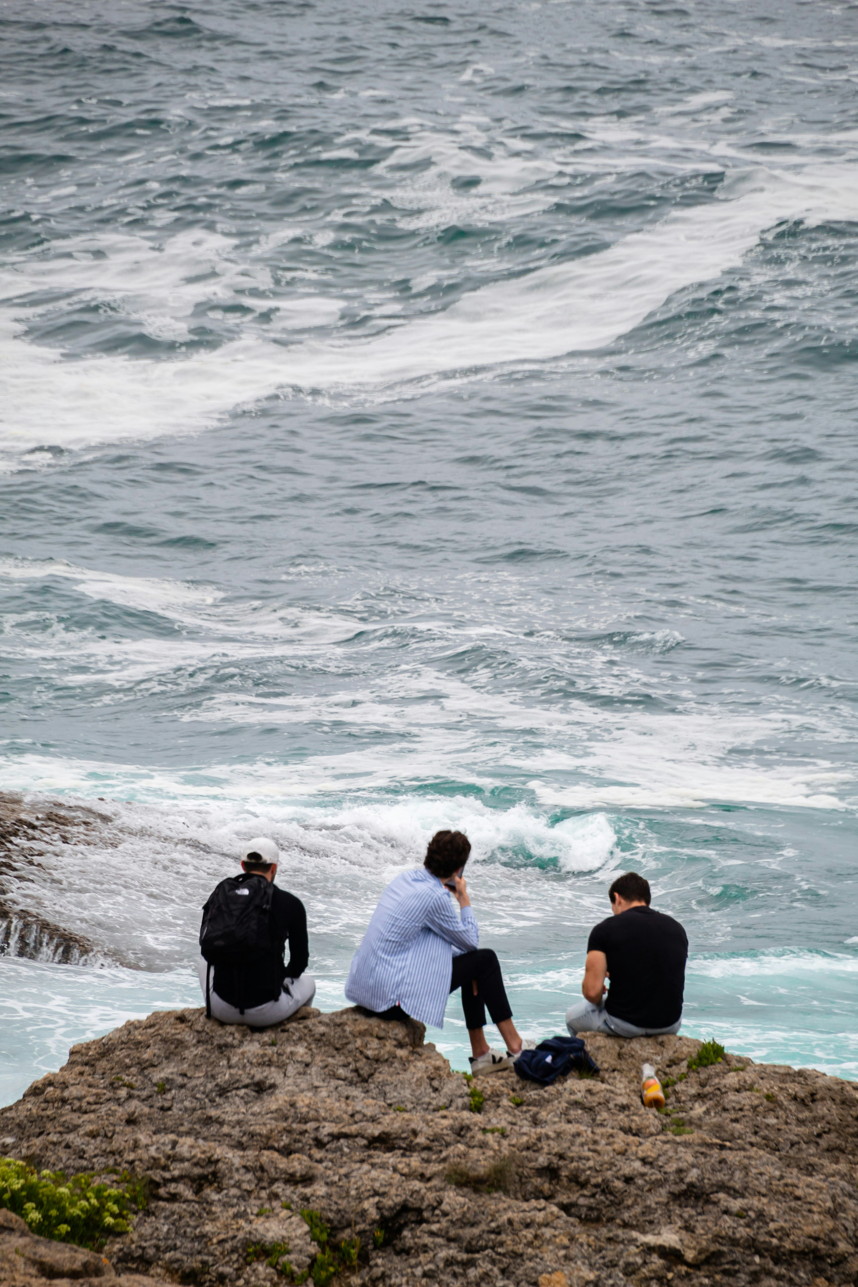 a group of people on a beach next to the ocean