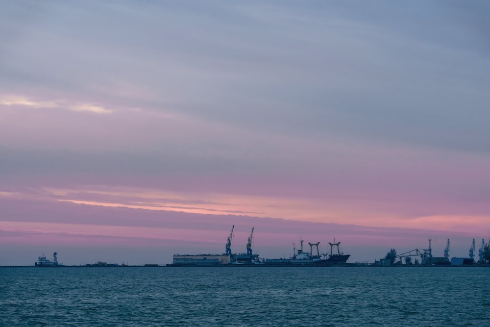 a large body of water with ships in the distance