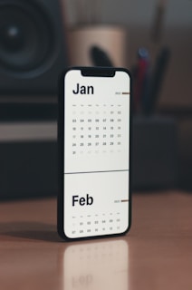 a calendar phone case sitting on top of a wooden table