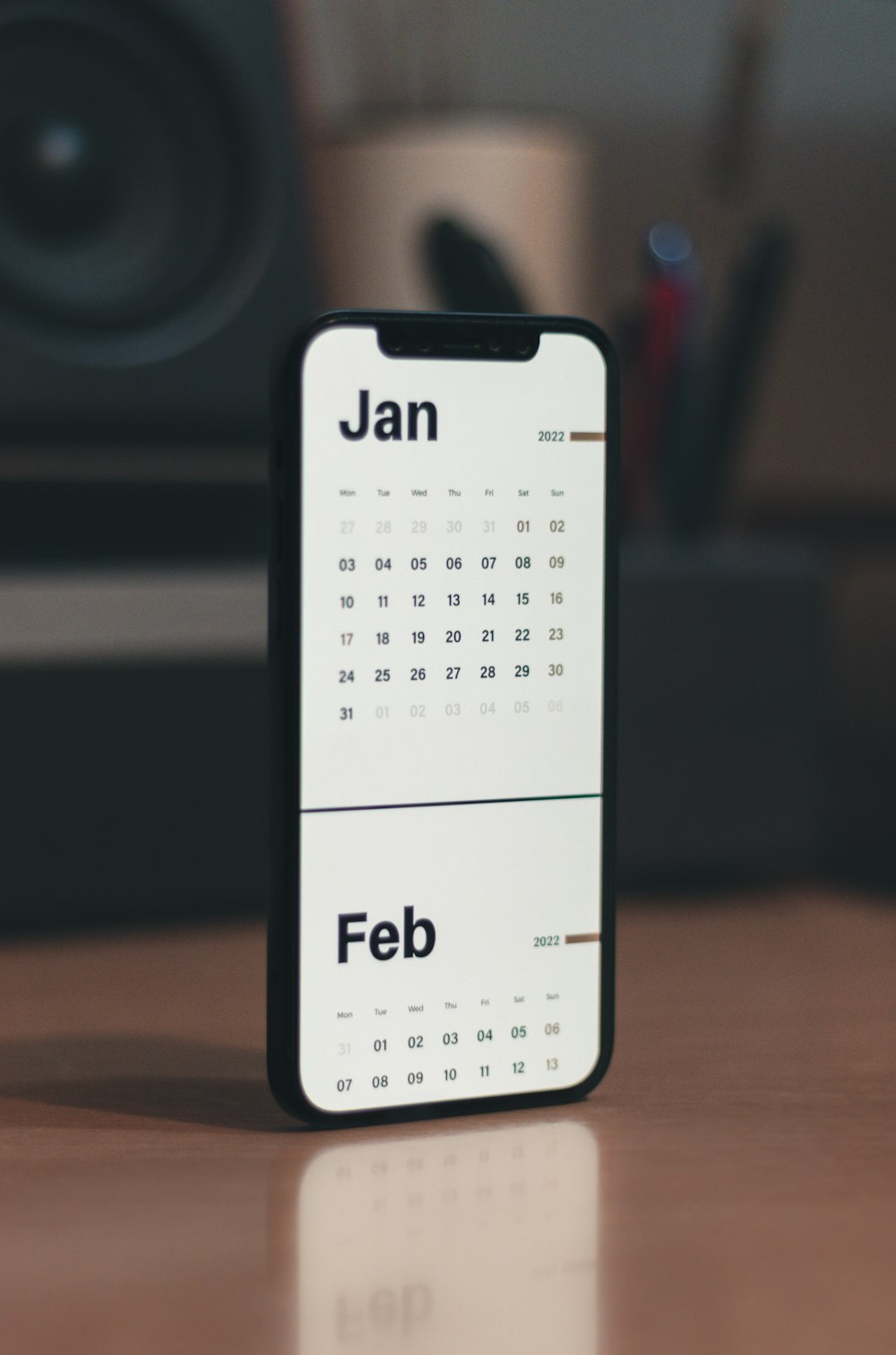 a calendar phone case sitting on top of a wooden table
