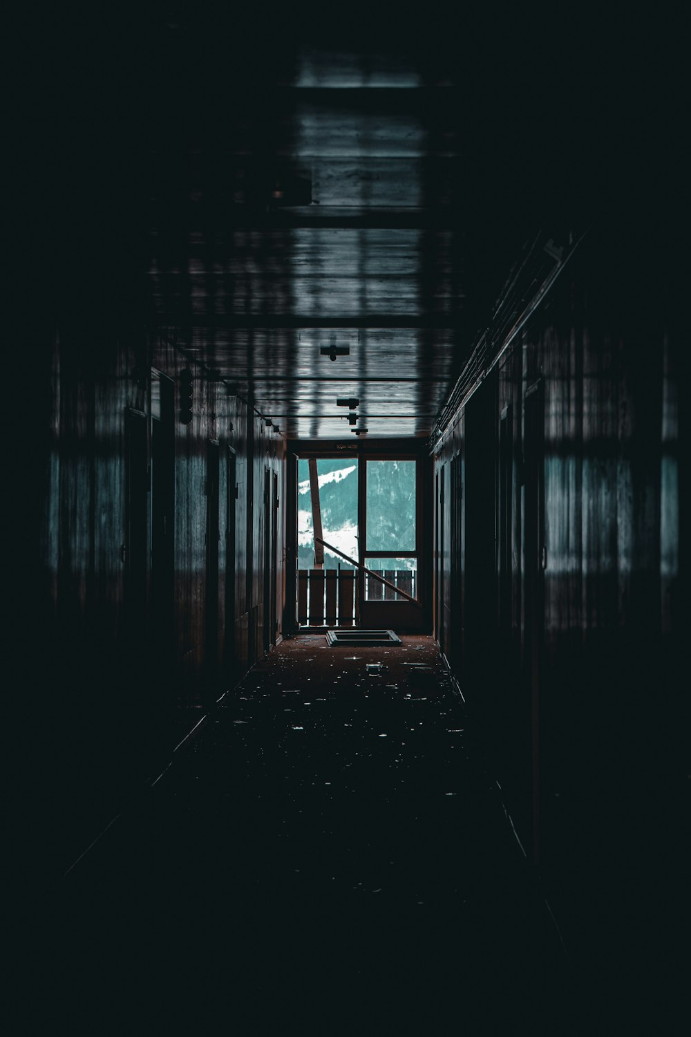a dark hallway with a view of a mountain