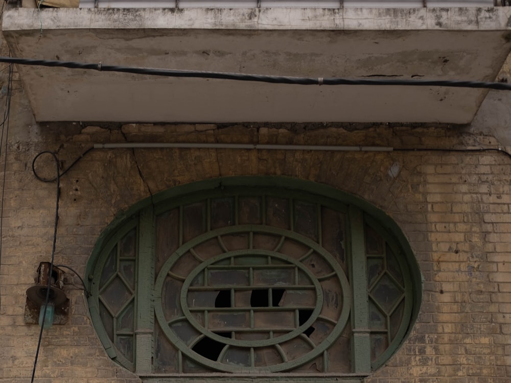 a clock on the side of a brick building