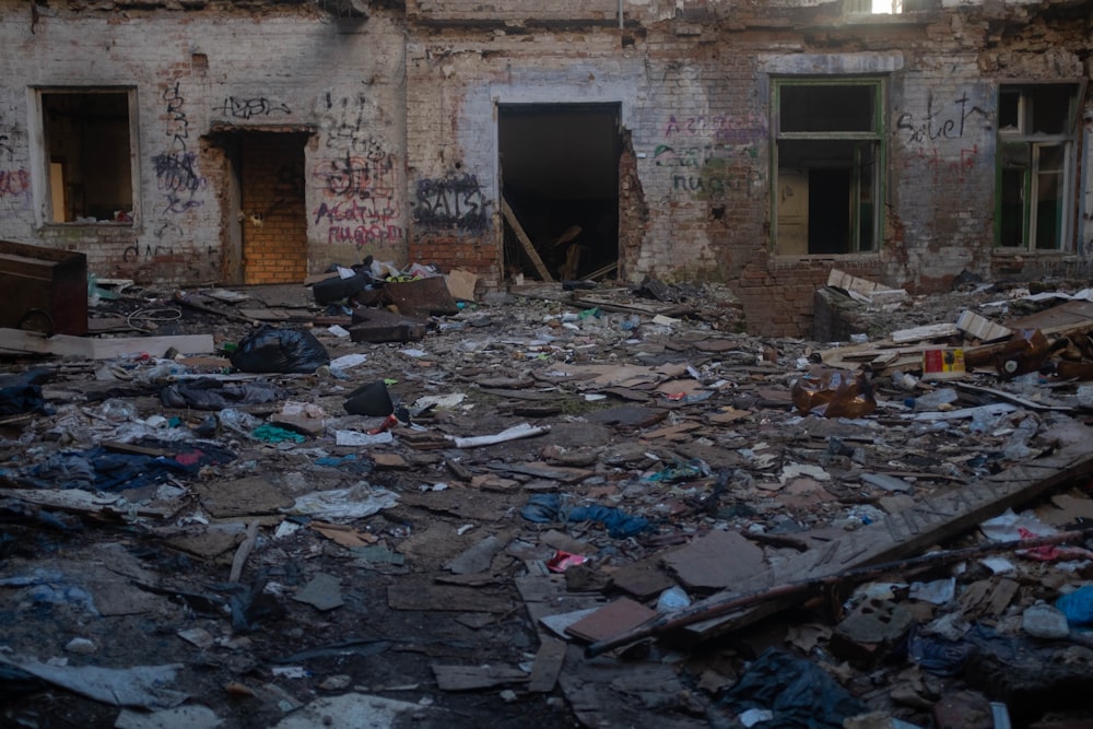 a run down building with lots of trash on the ground