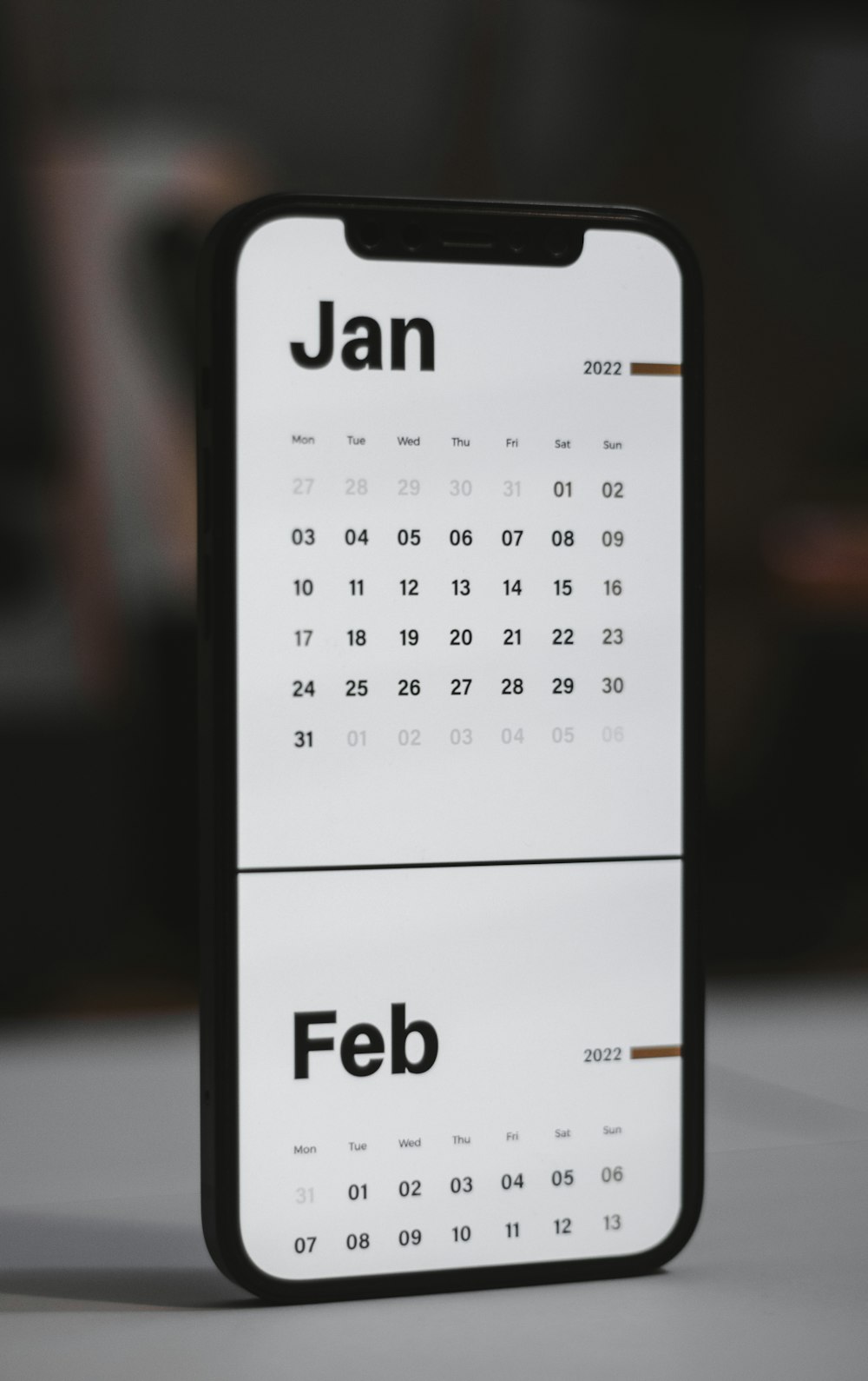 a white and black calendar phone case sitting on top of a table
