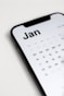 a close up of a cell phone with a calendar on it